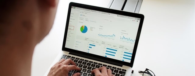Man at laptop open to marketing automation single dashboard screen